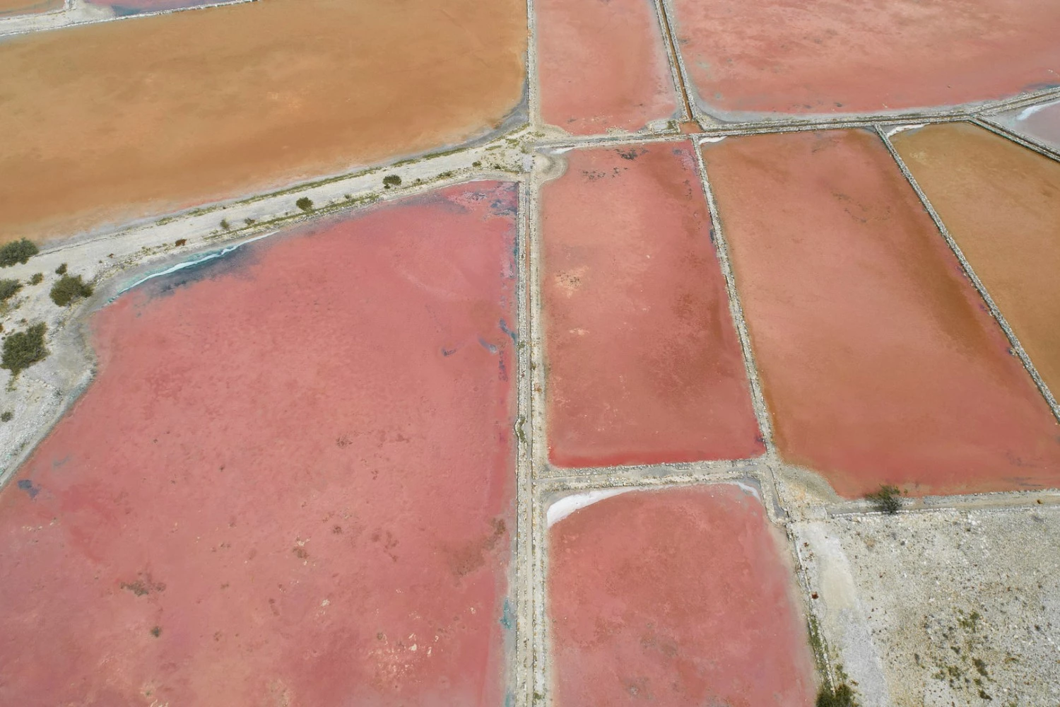 a aerial view of a large area with red and brown land