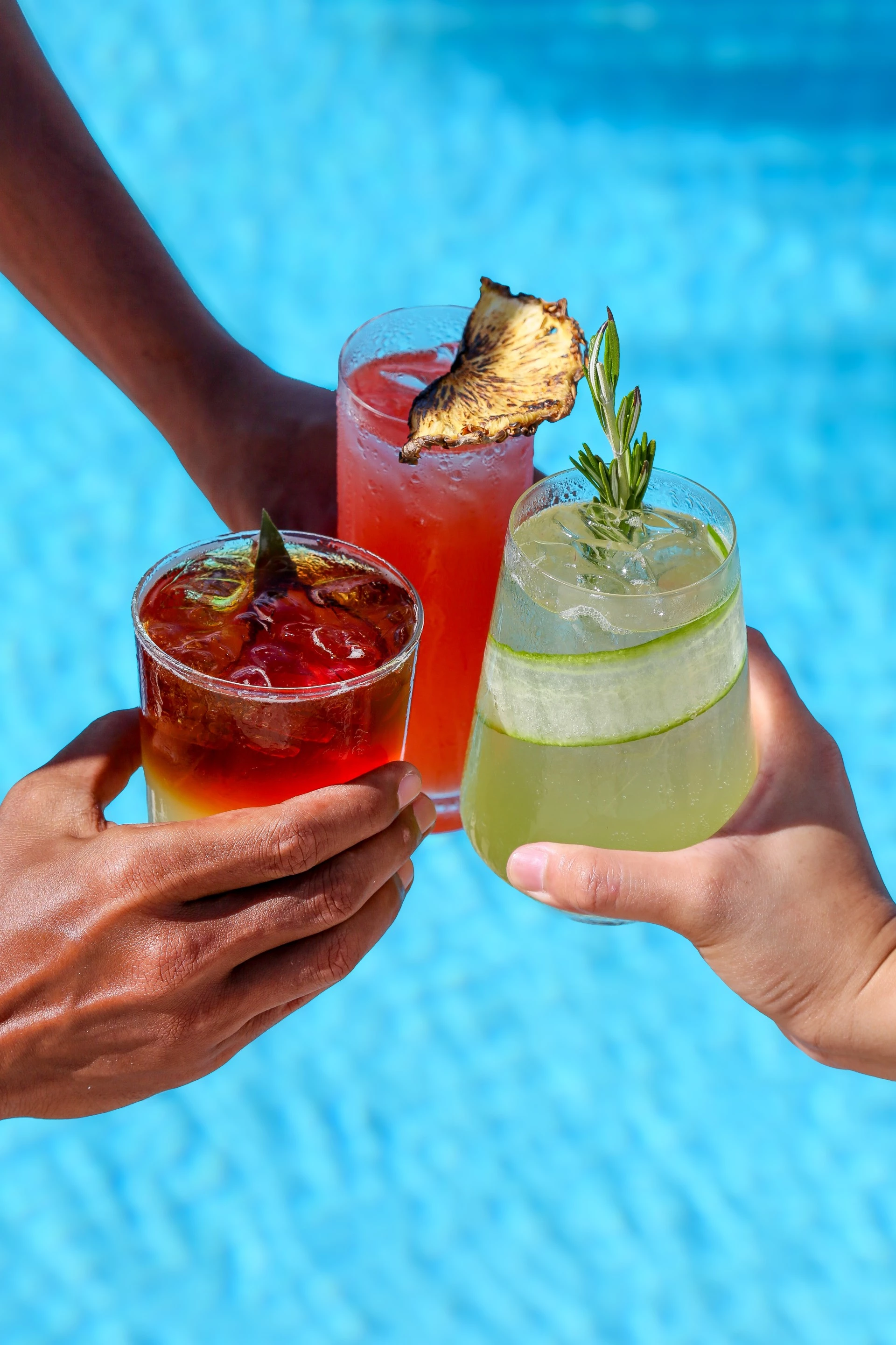a group of hands holding drinks