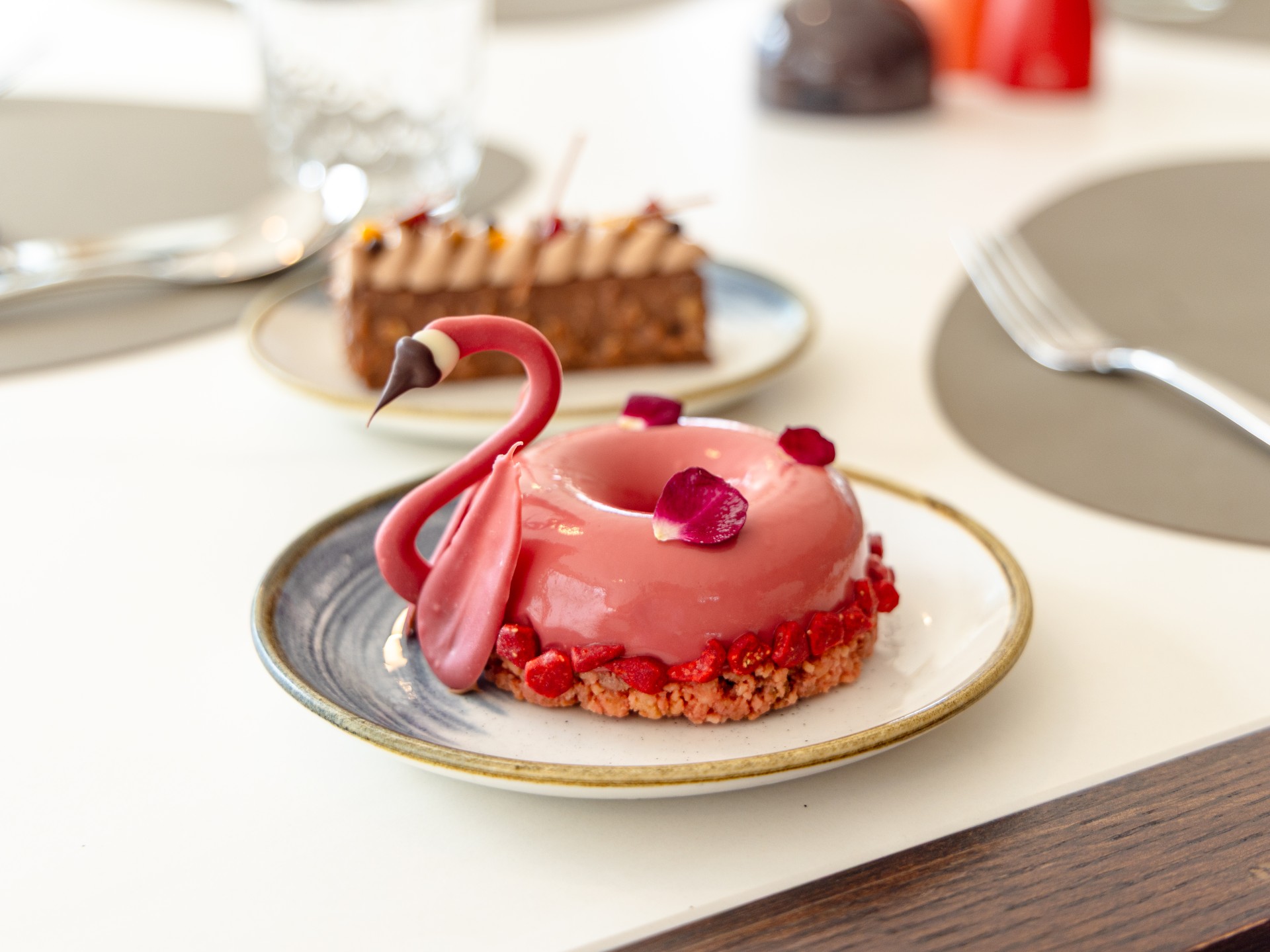 a pink donut on a plate
