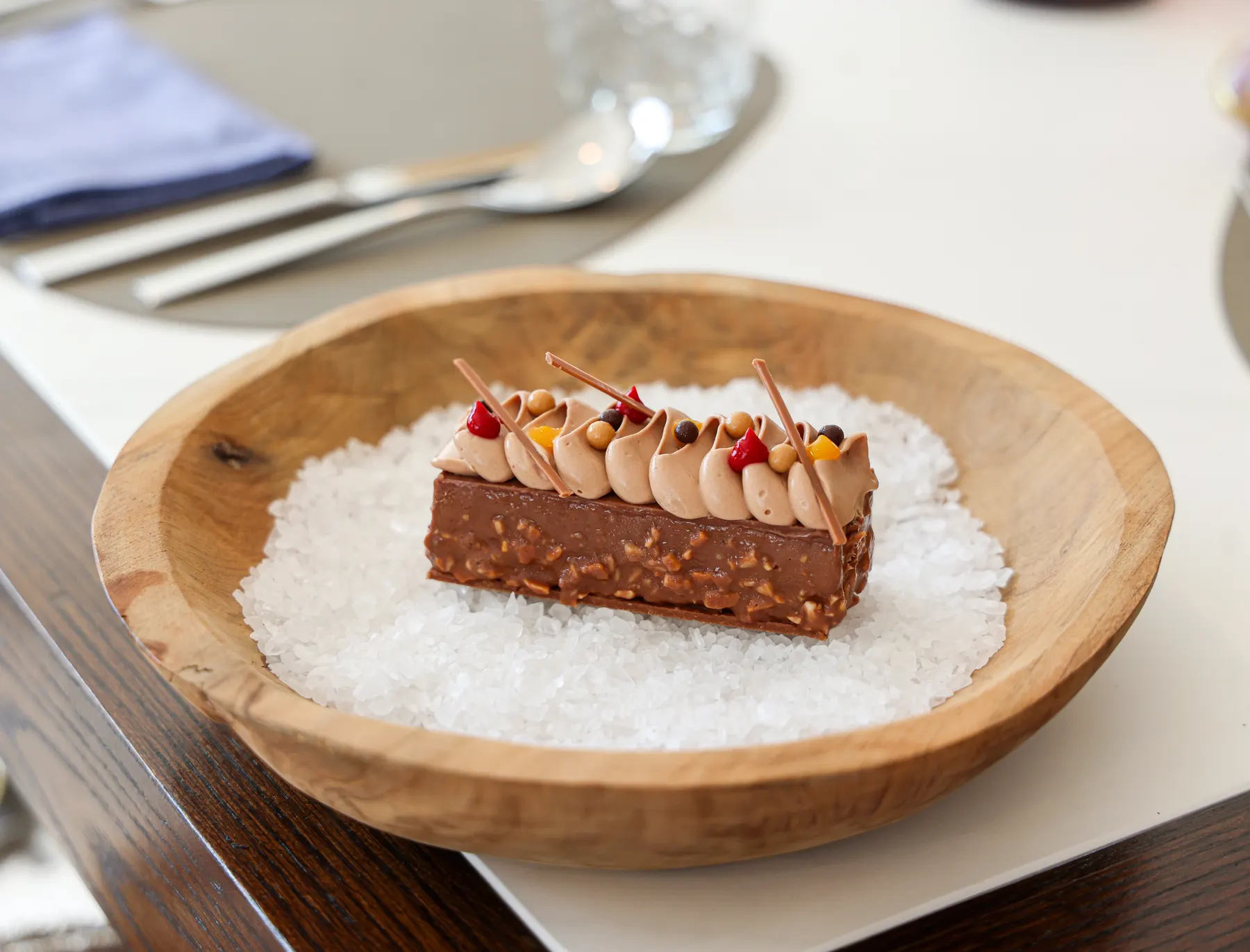 a piece of chocolate cake on a bowl of salt