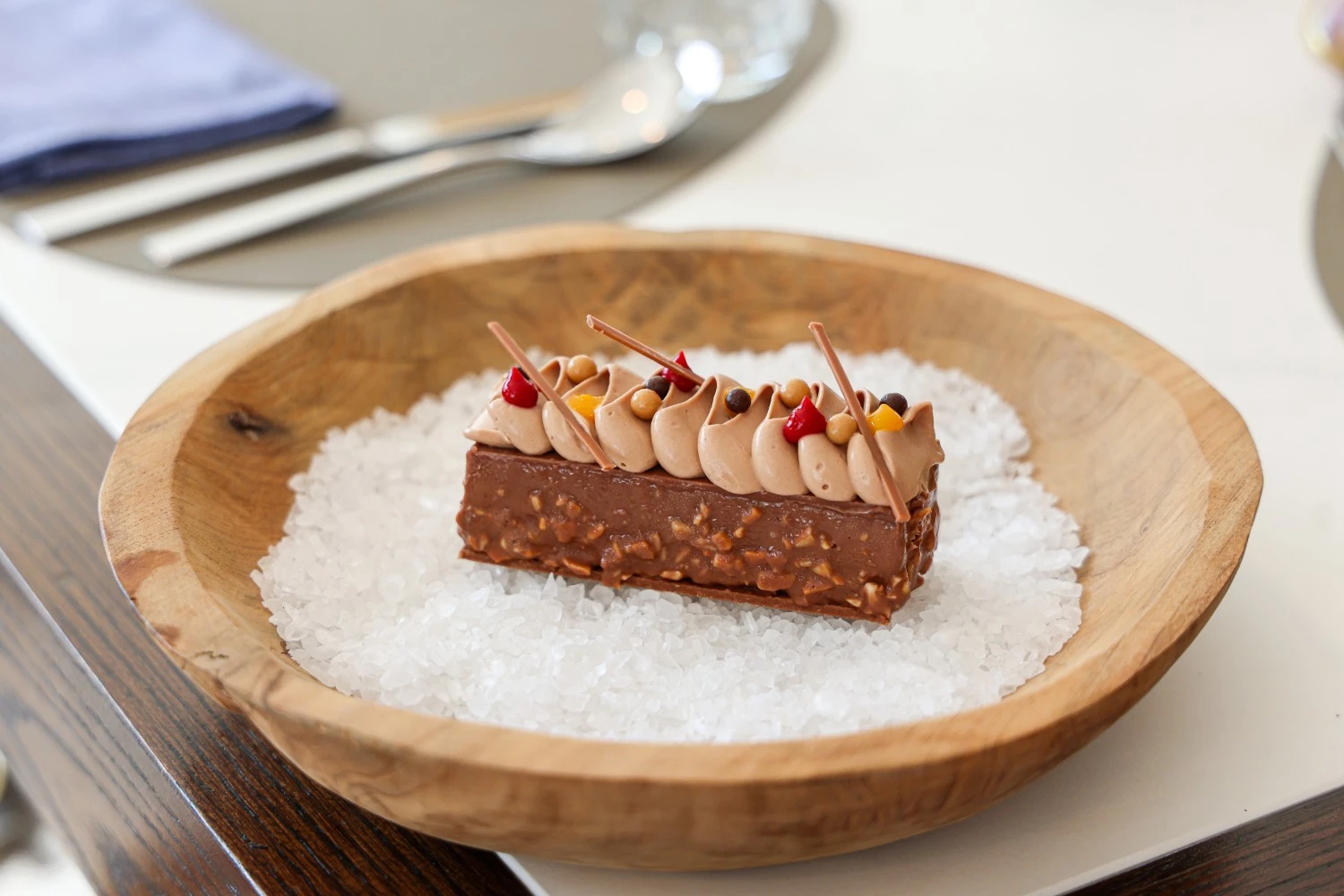 a piece of chocolate cake on a bowl of salt