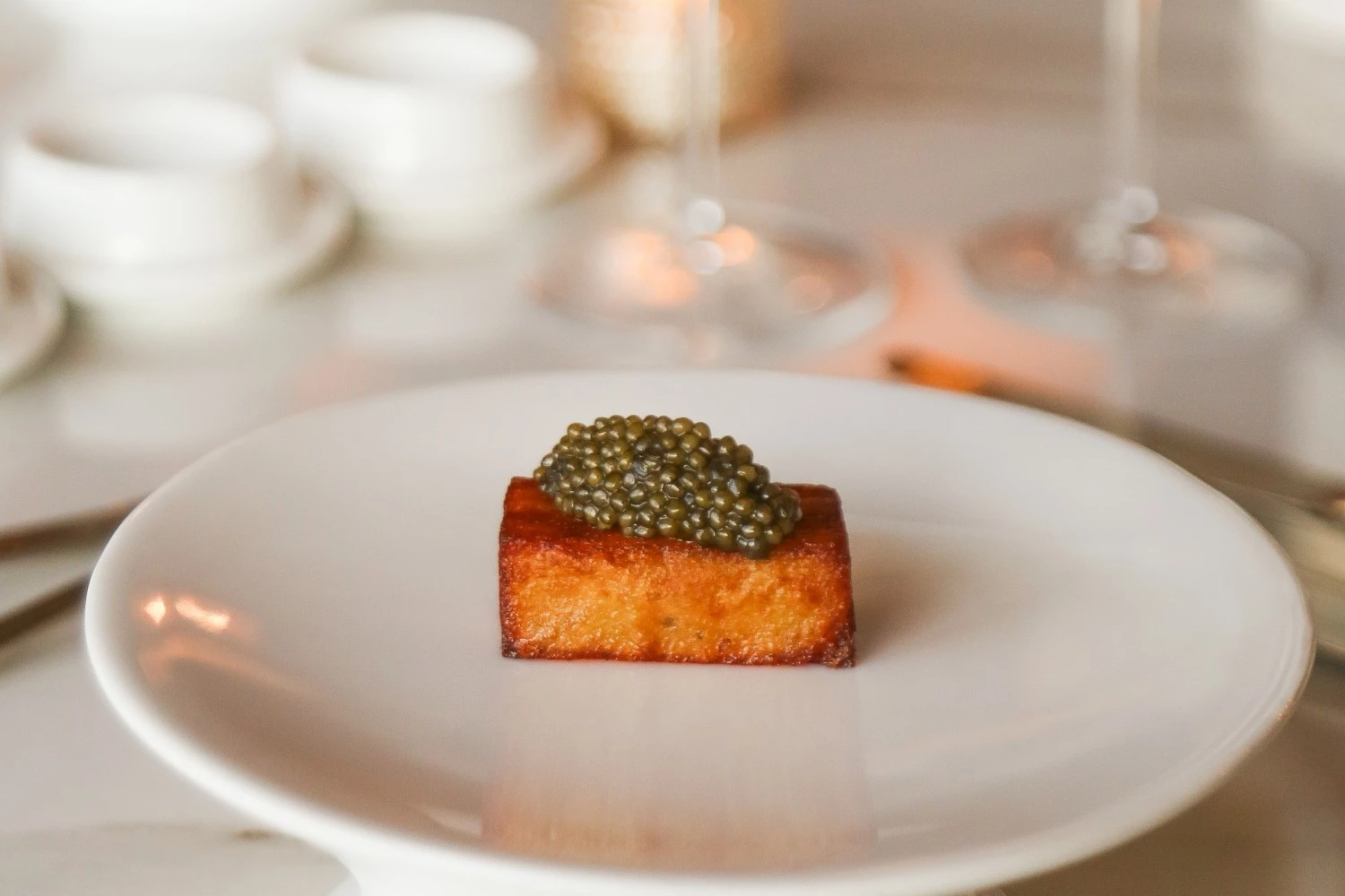 a small piece of food on a white plate