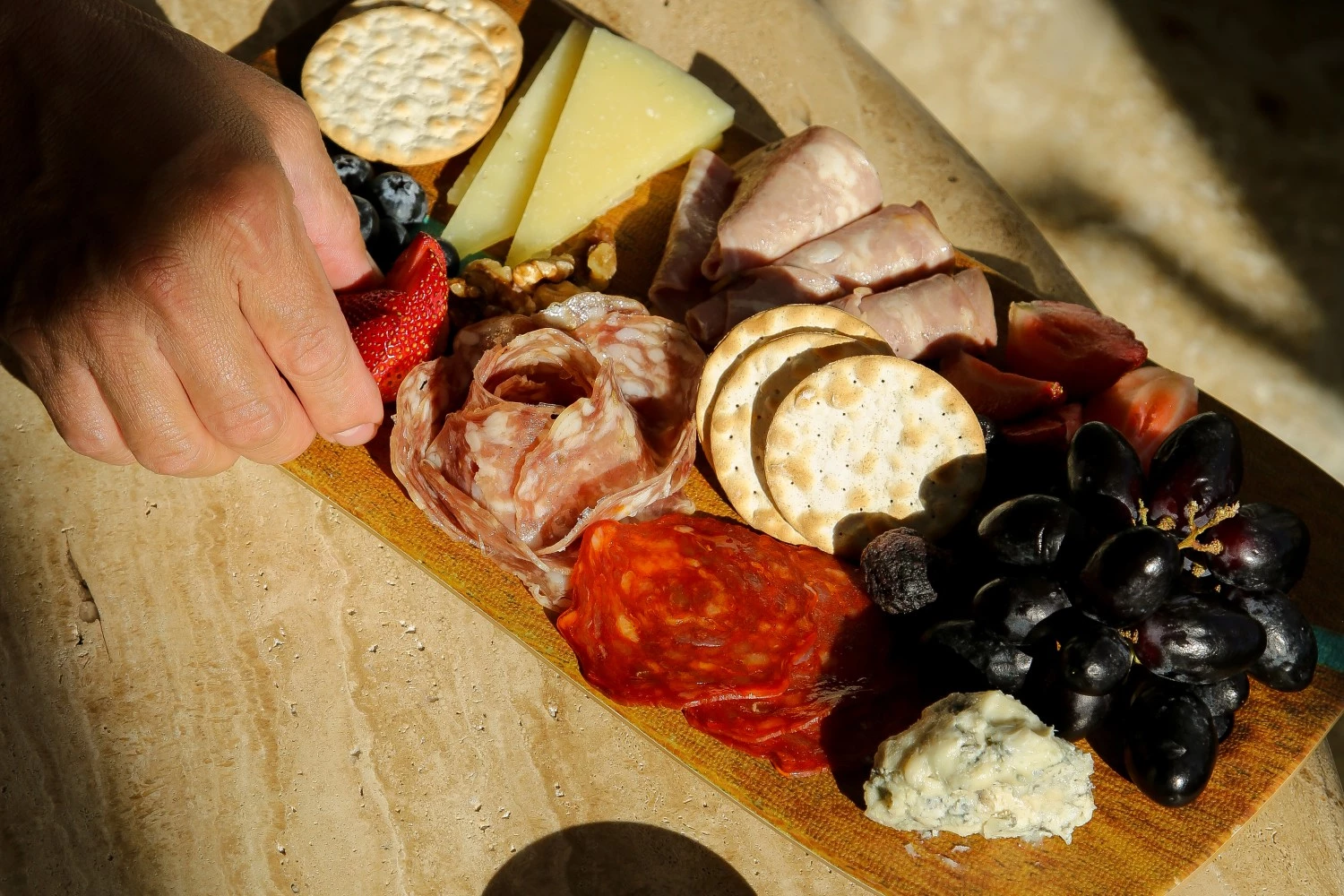 a hand holding a platter of food
