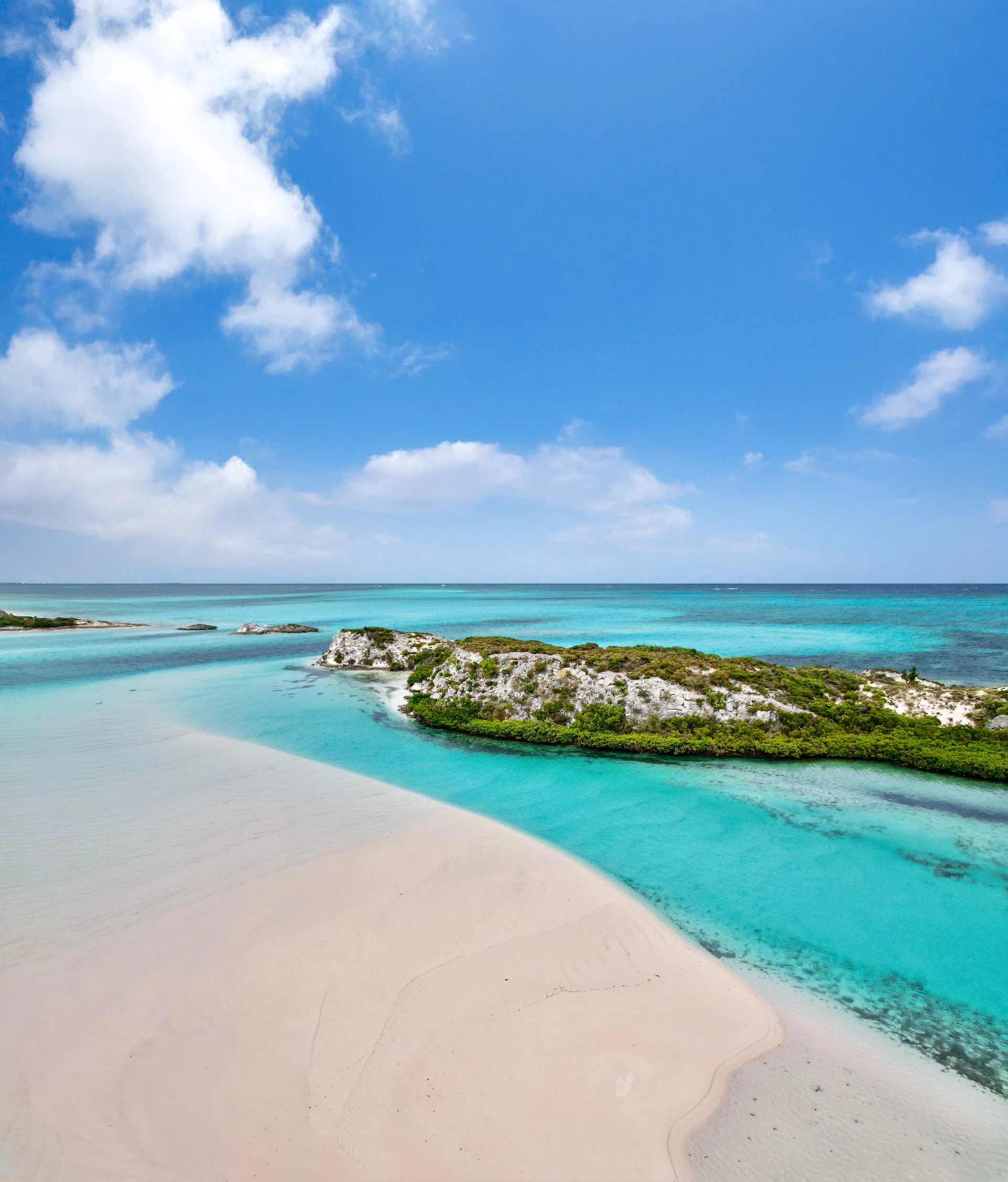 a beach with a small island in the water