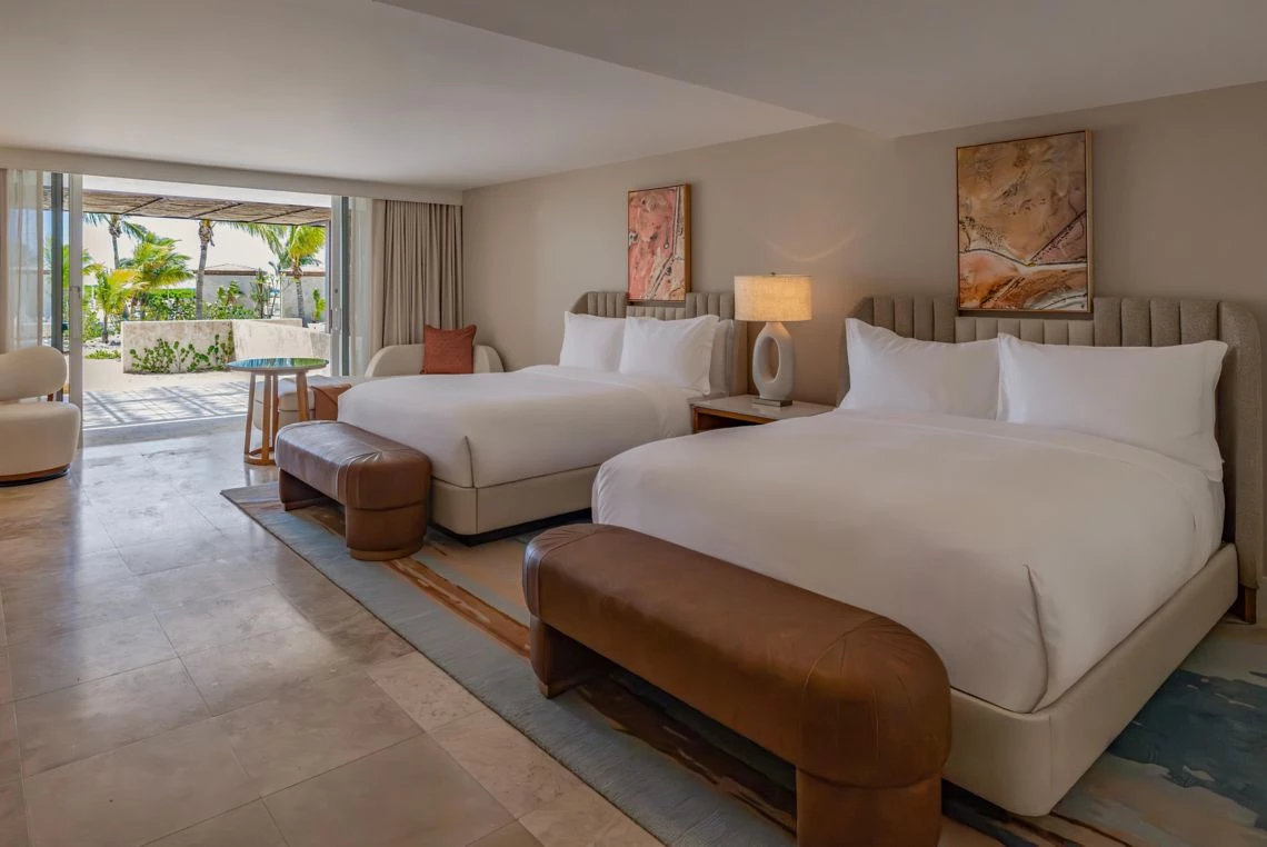 a room with two beds and a table