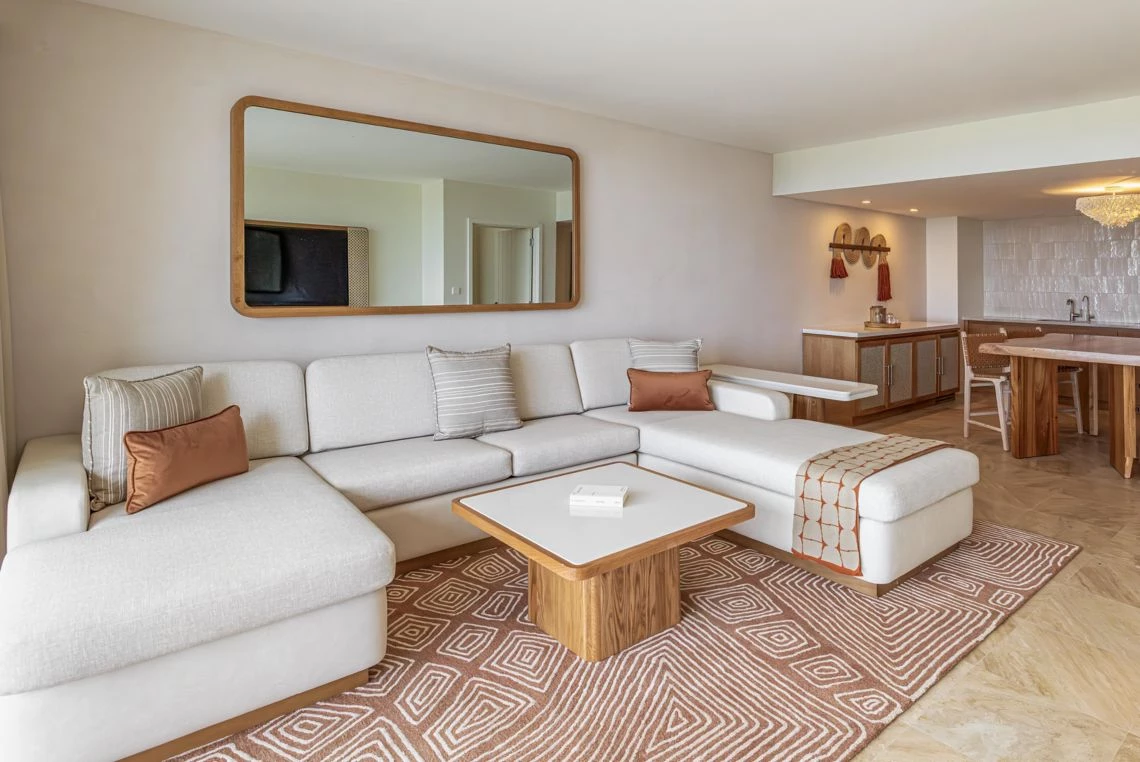 a living room with a large mirror and a couch