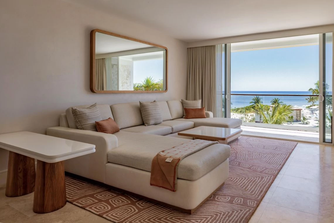 a living room with a large couch and a mirror