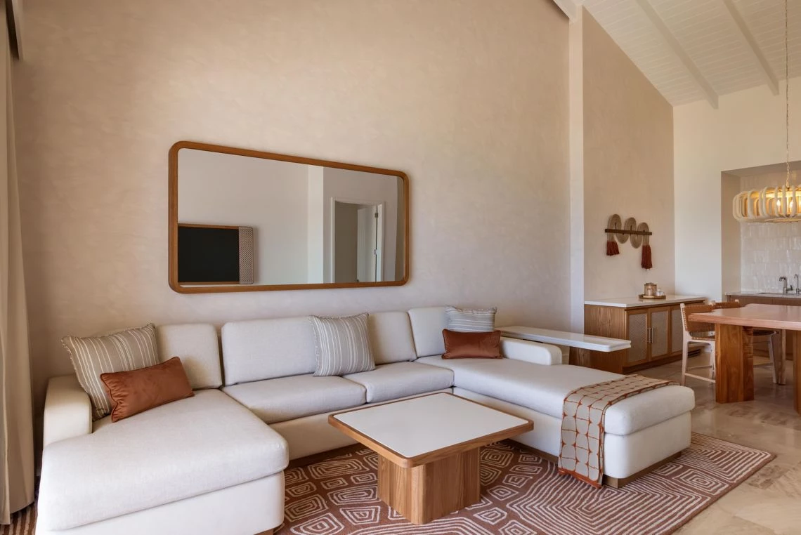 a living room with a large mirror and a couch