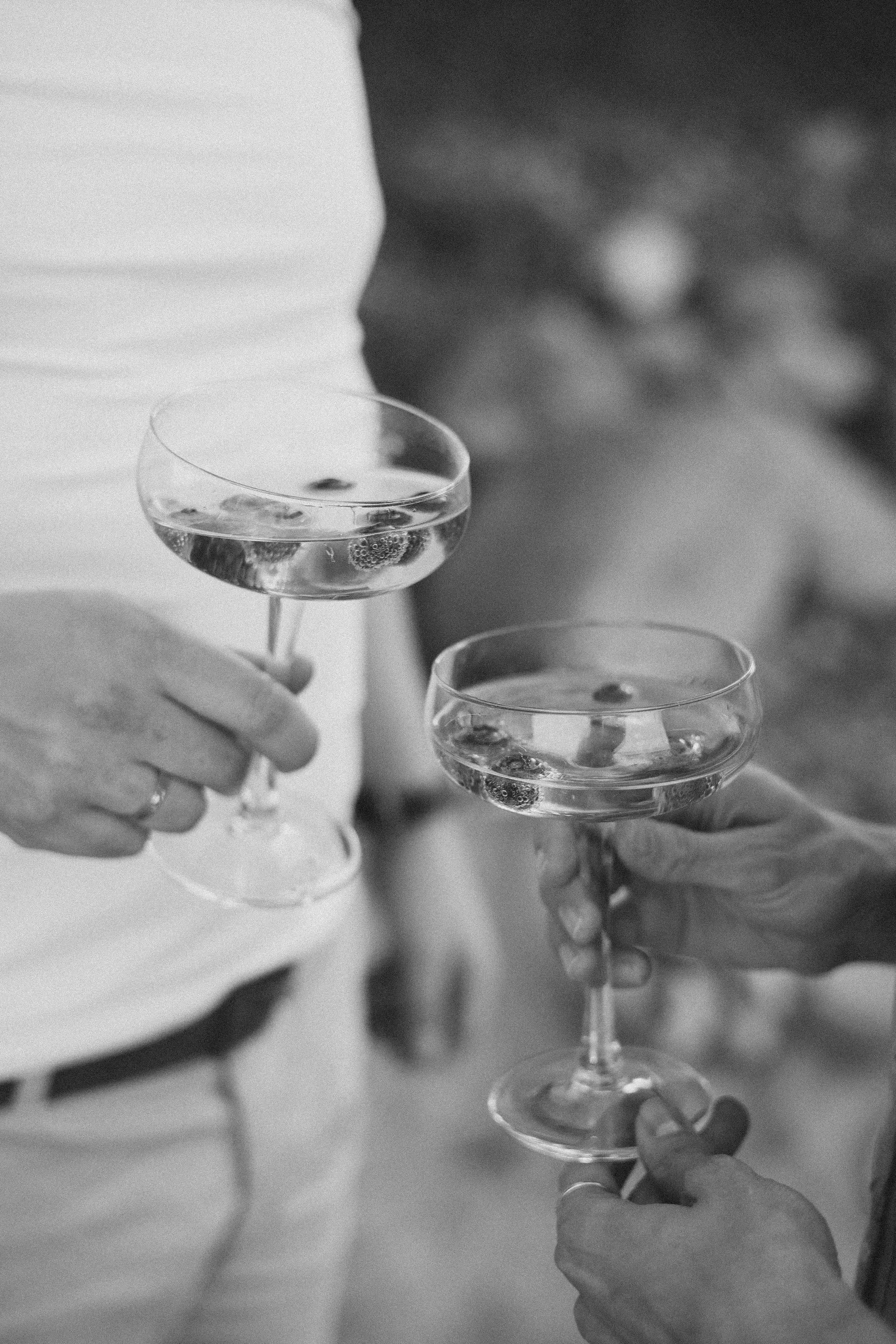 a person holding glasses of champagne
