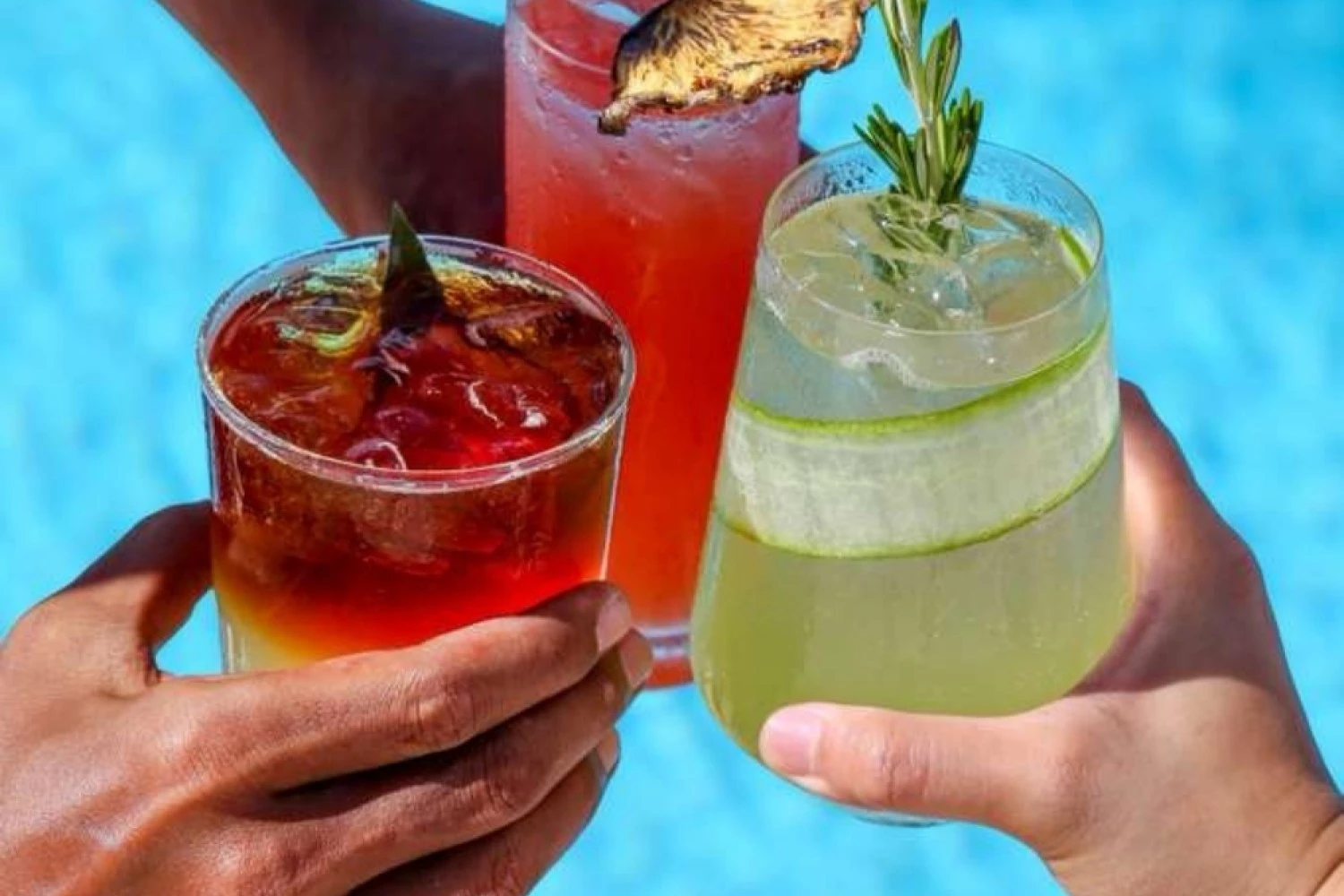 a group of hands holding drinks