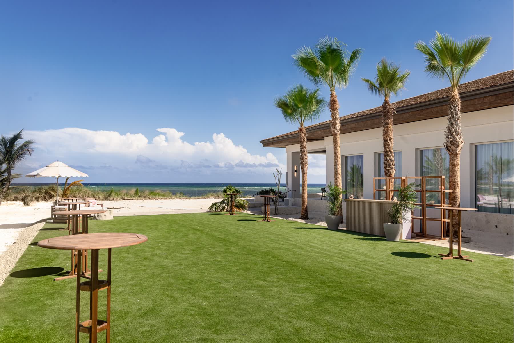 a house with palm trees and a beach