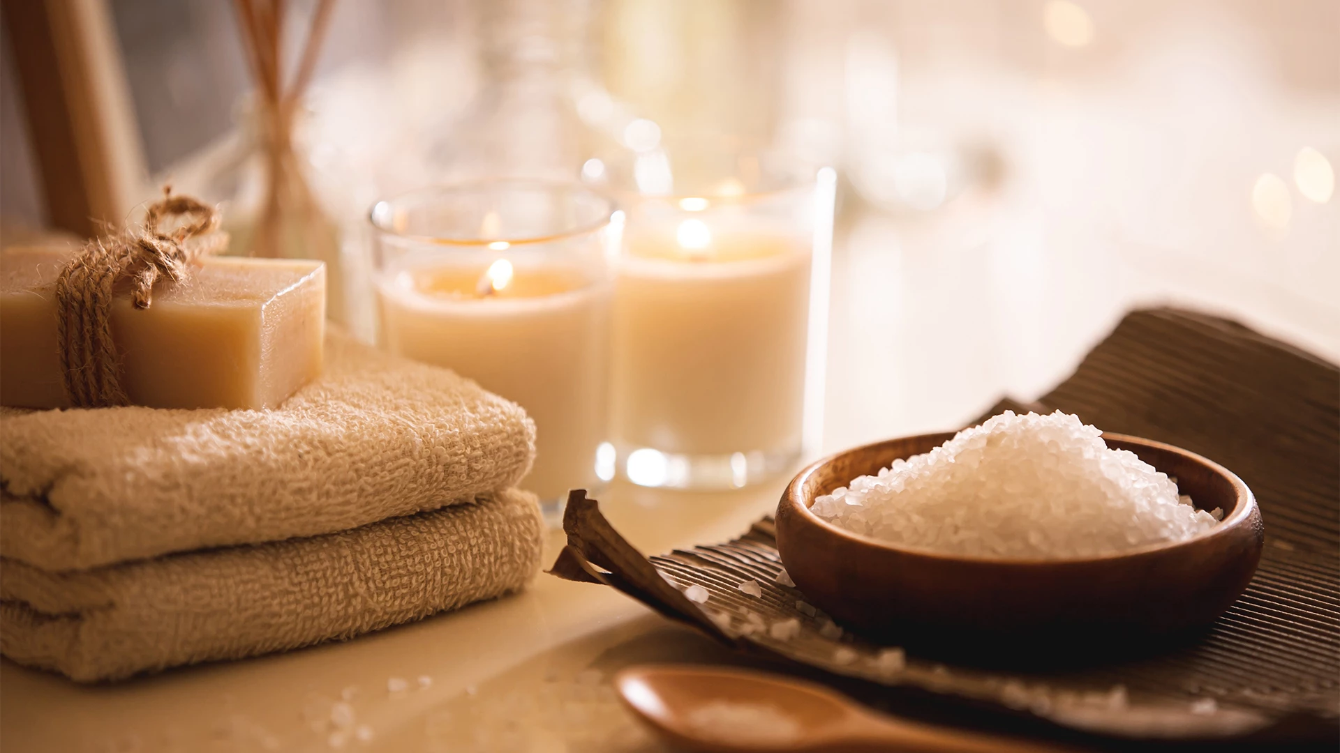a bath salt and towels with candles