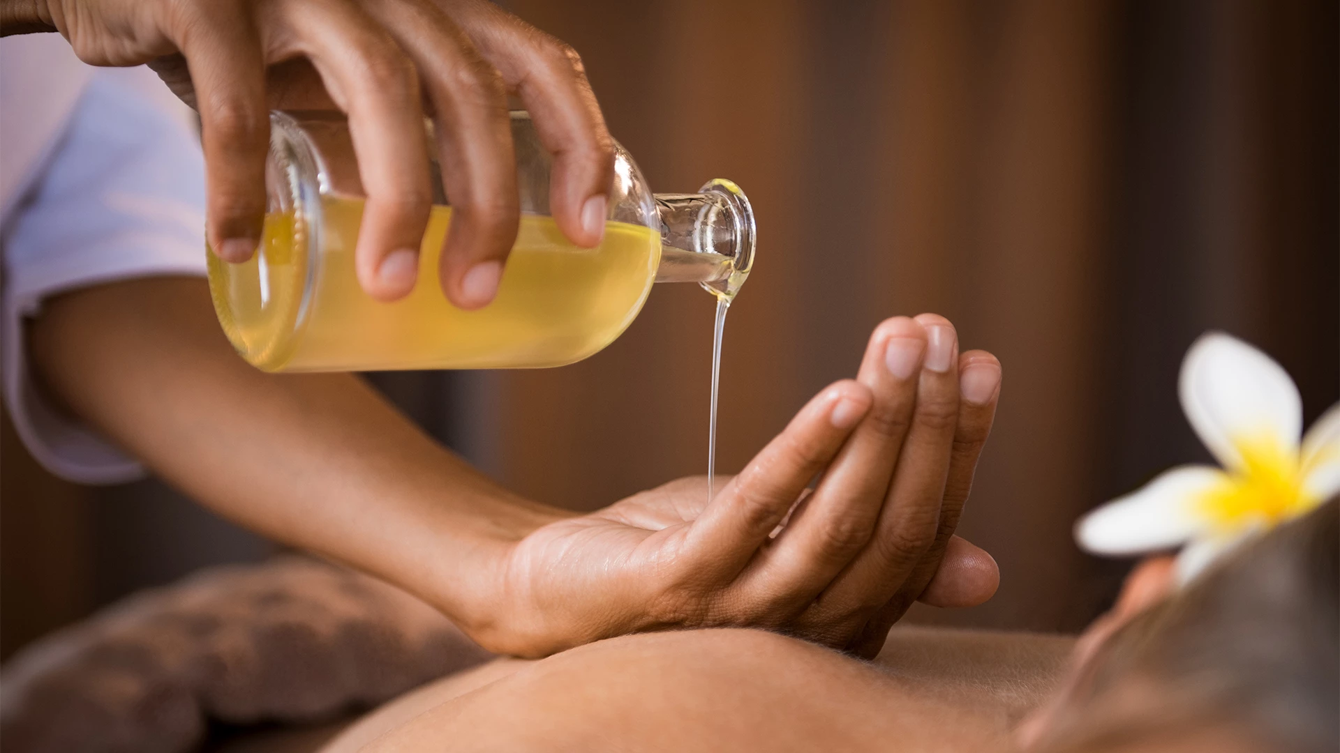 a person pouring a liquid onto a person's hand