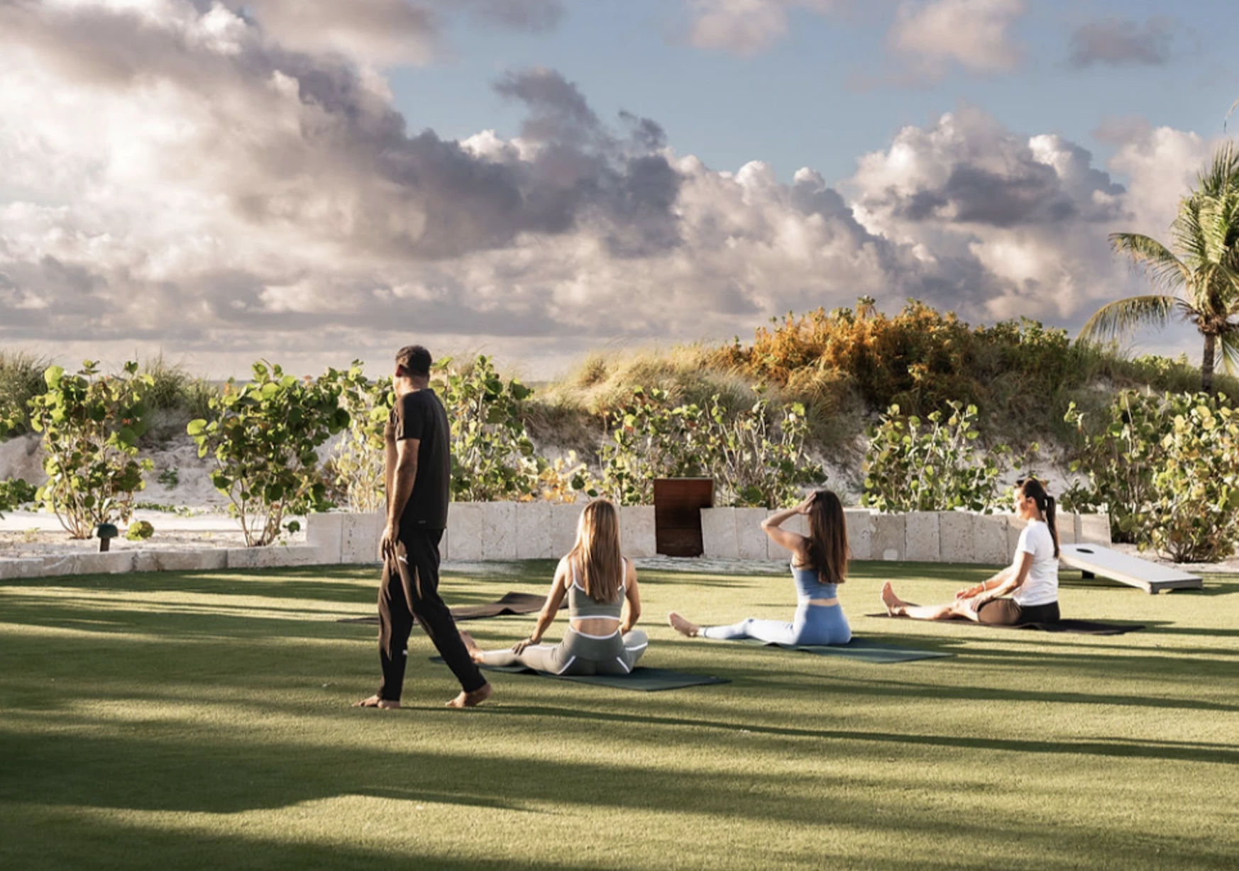 a group of people sitting on a grass field