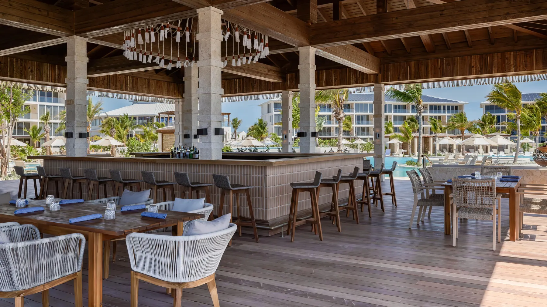 a patio with a bar and chairs