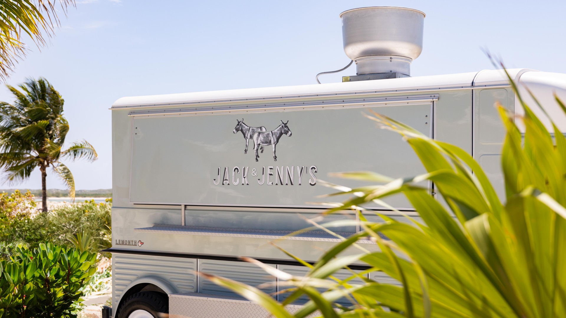 a blue food truck with a picture of donkeys on the side