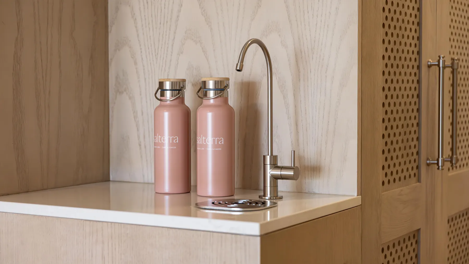 two pink bottles on a counter