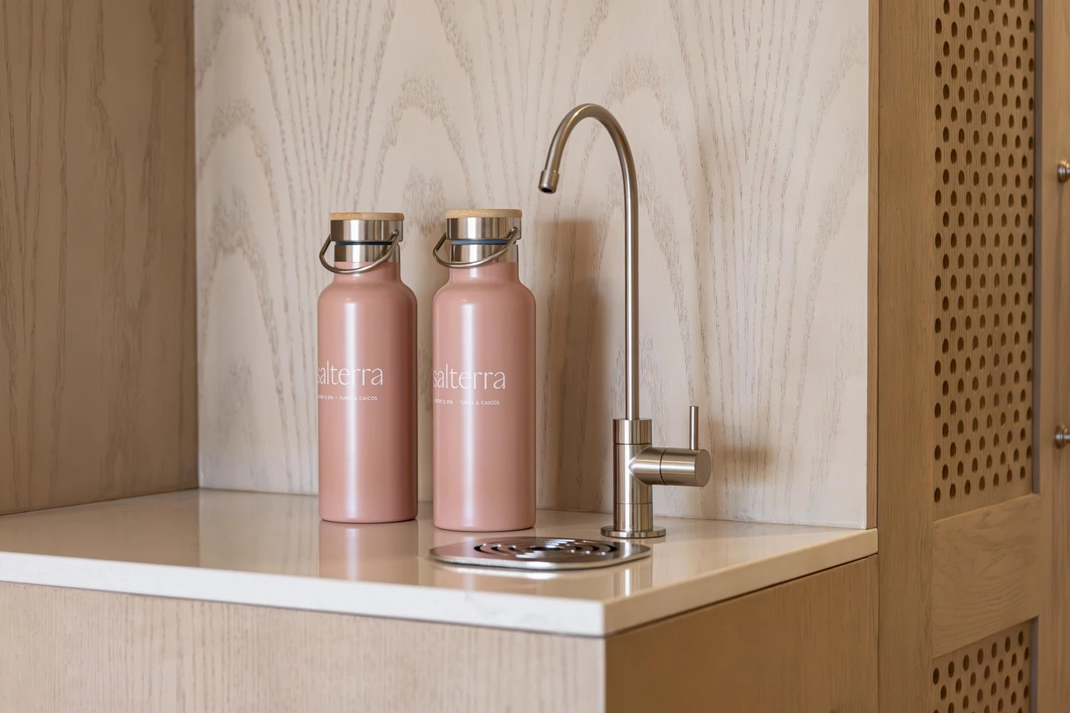 two pink bottles on a counter