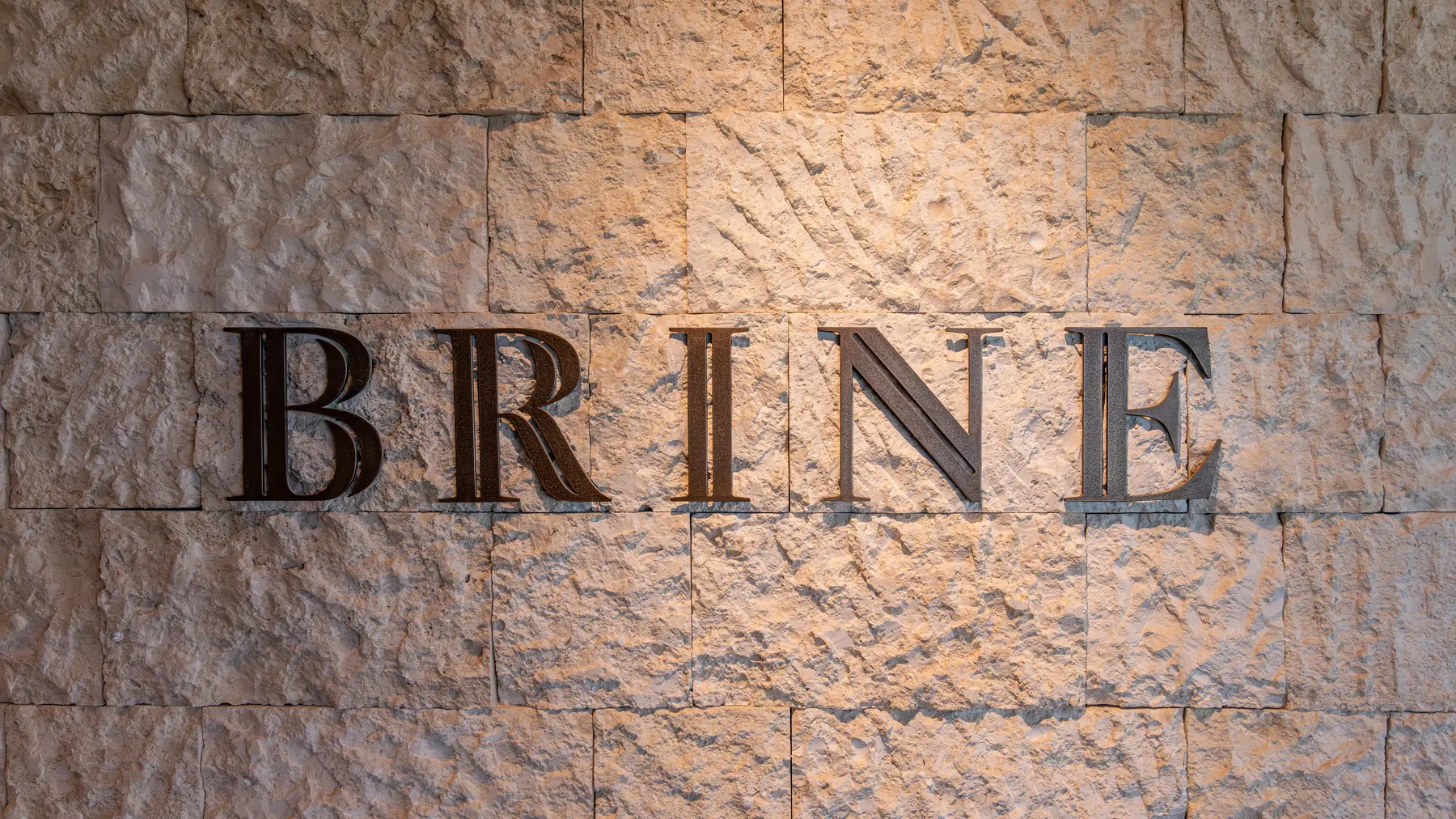 a stone wall with letters on it