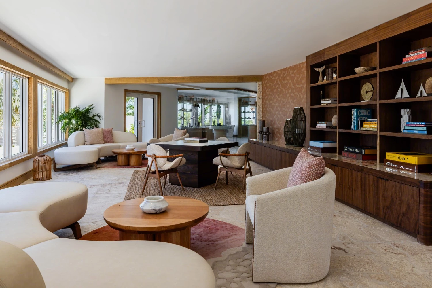 a living room with white furniture and a table