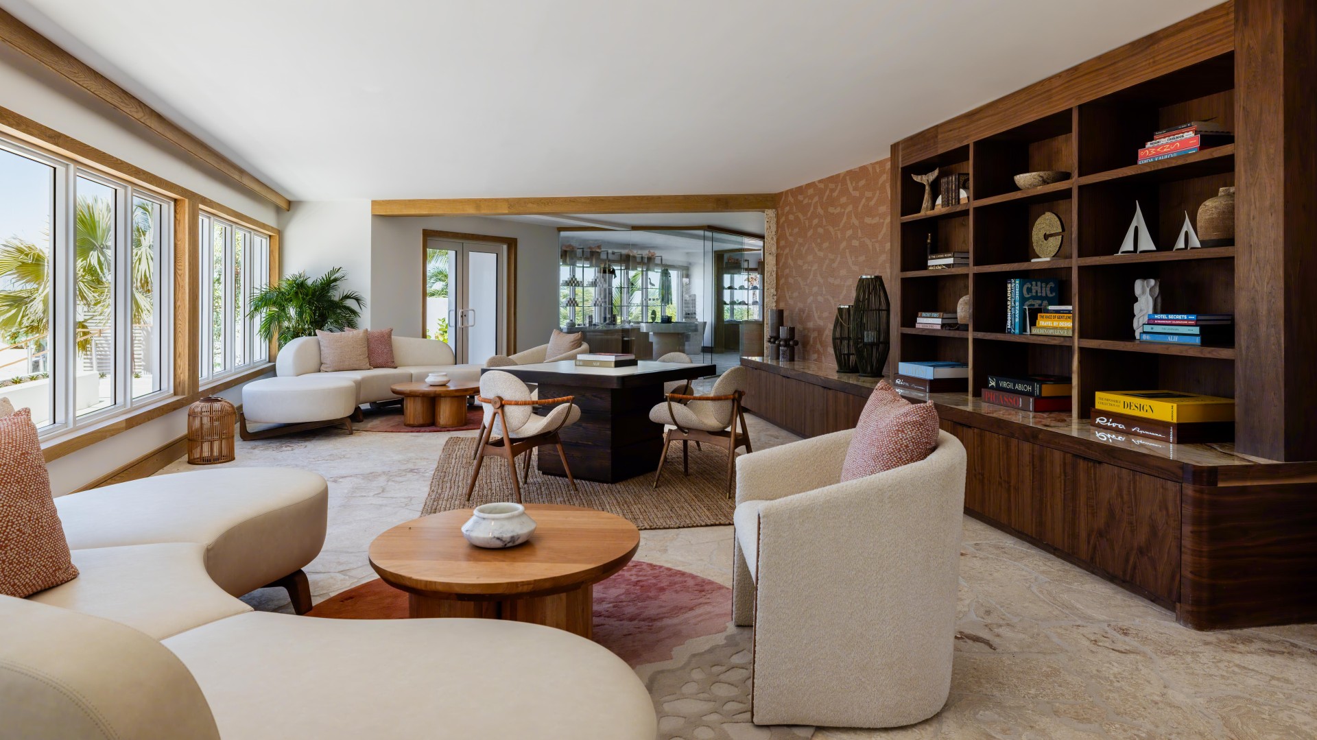 a living room with white furniture and a table