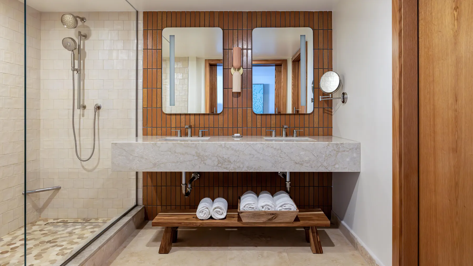 a bathroom with a double sink and two mirrors