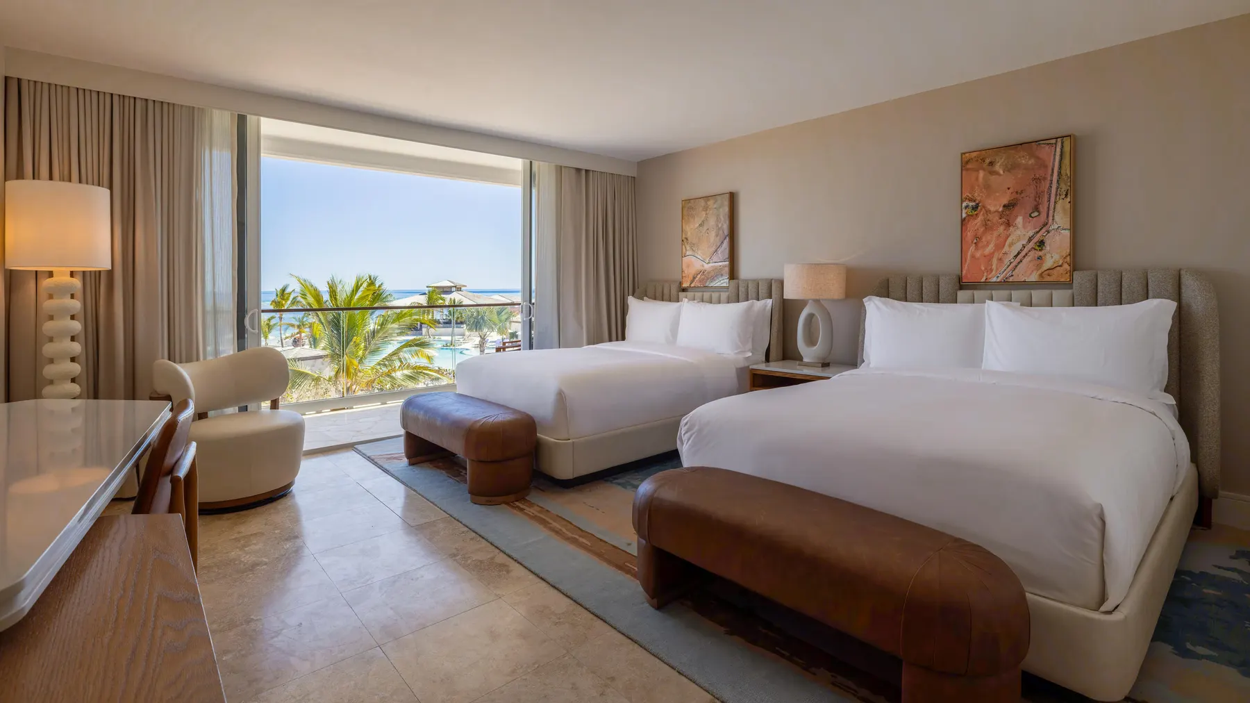 a room with two beds and a large window
