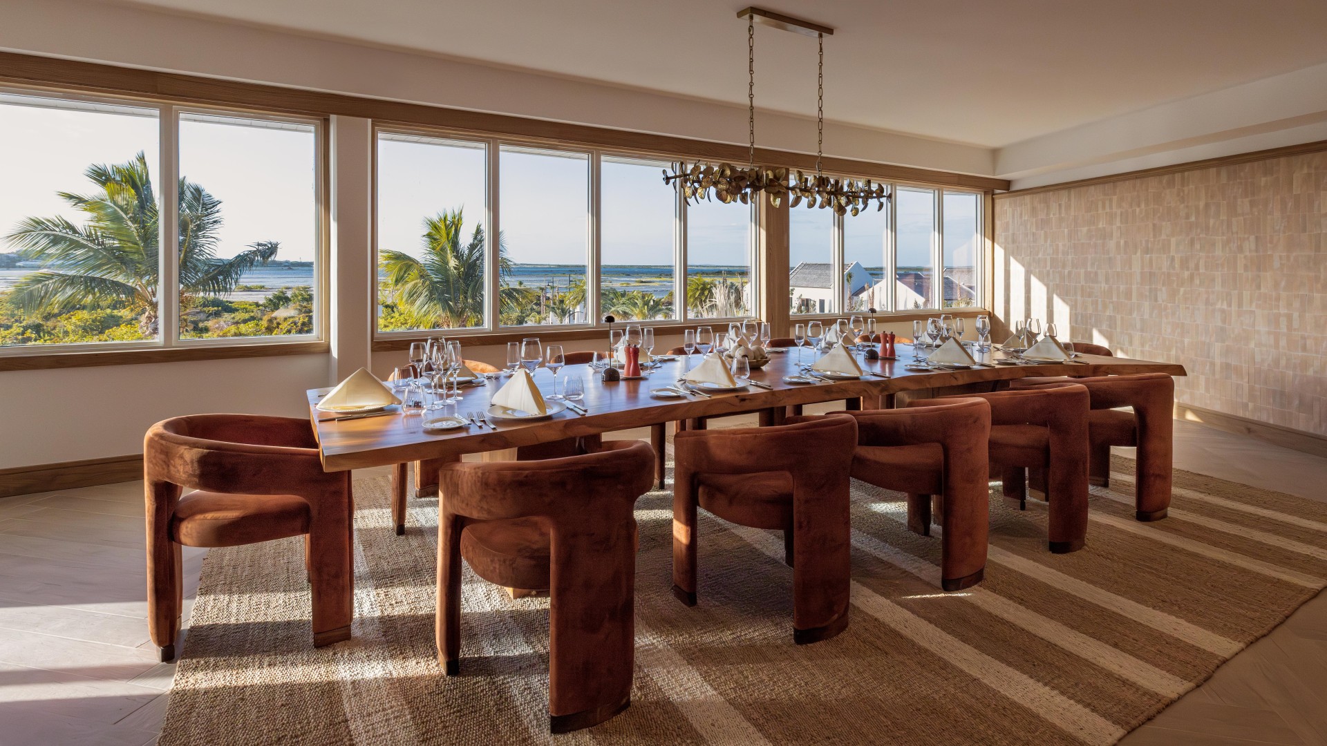 a large table with chairs and glasses