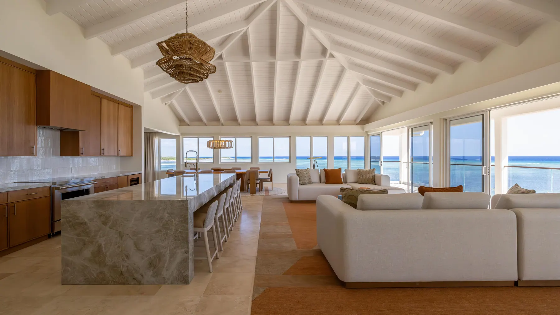 a living room with a large island and a large kitchen