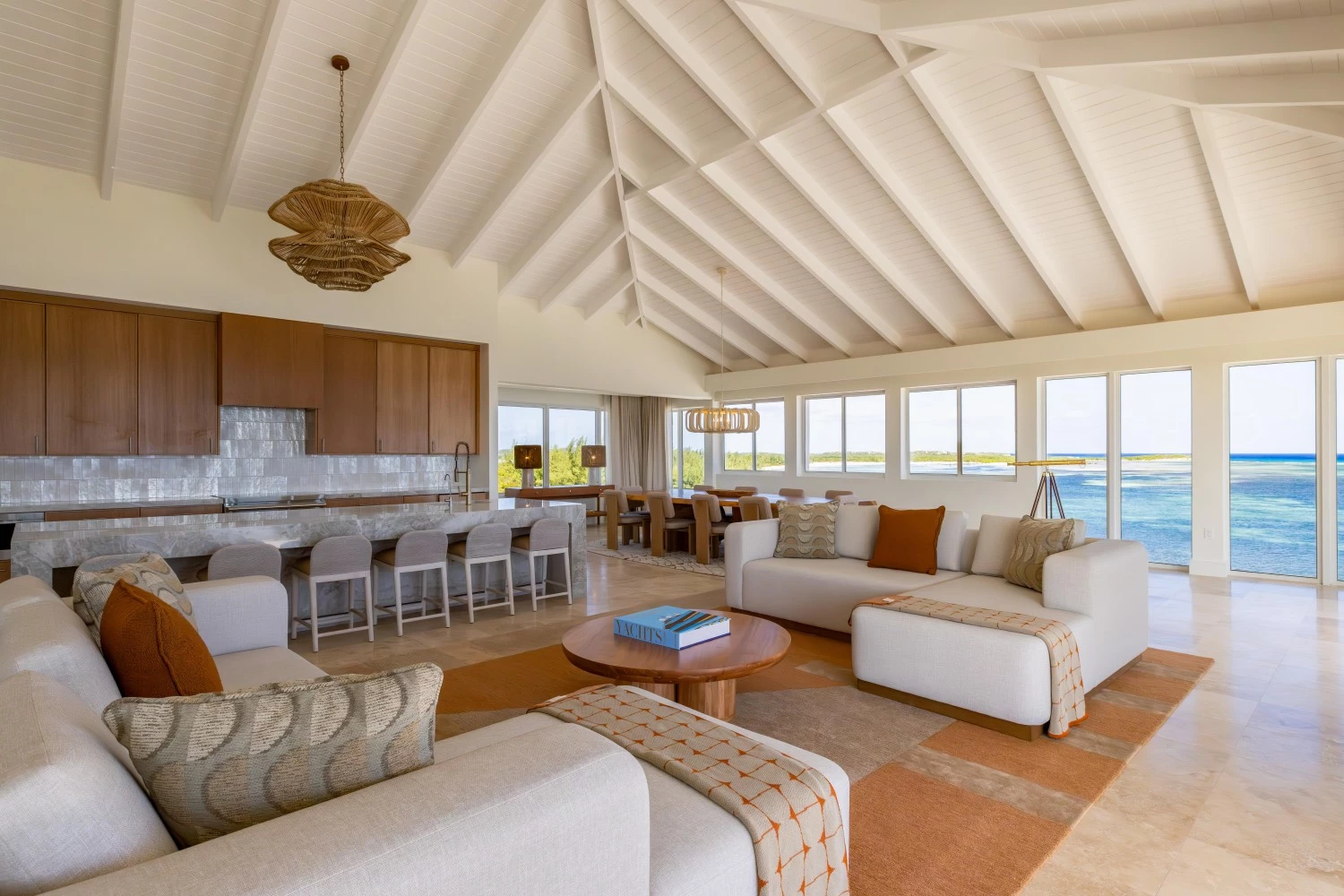 a living room with a large kitchen and dining area