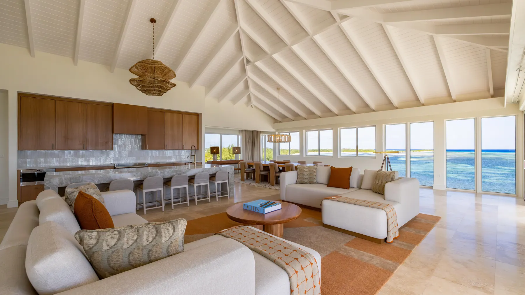 a living room with a large kitchen and dining area