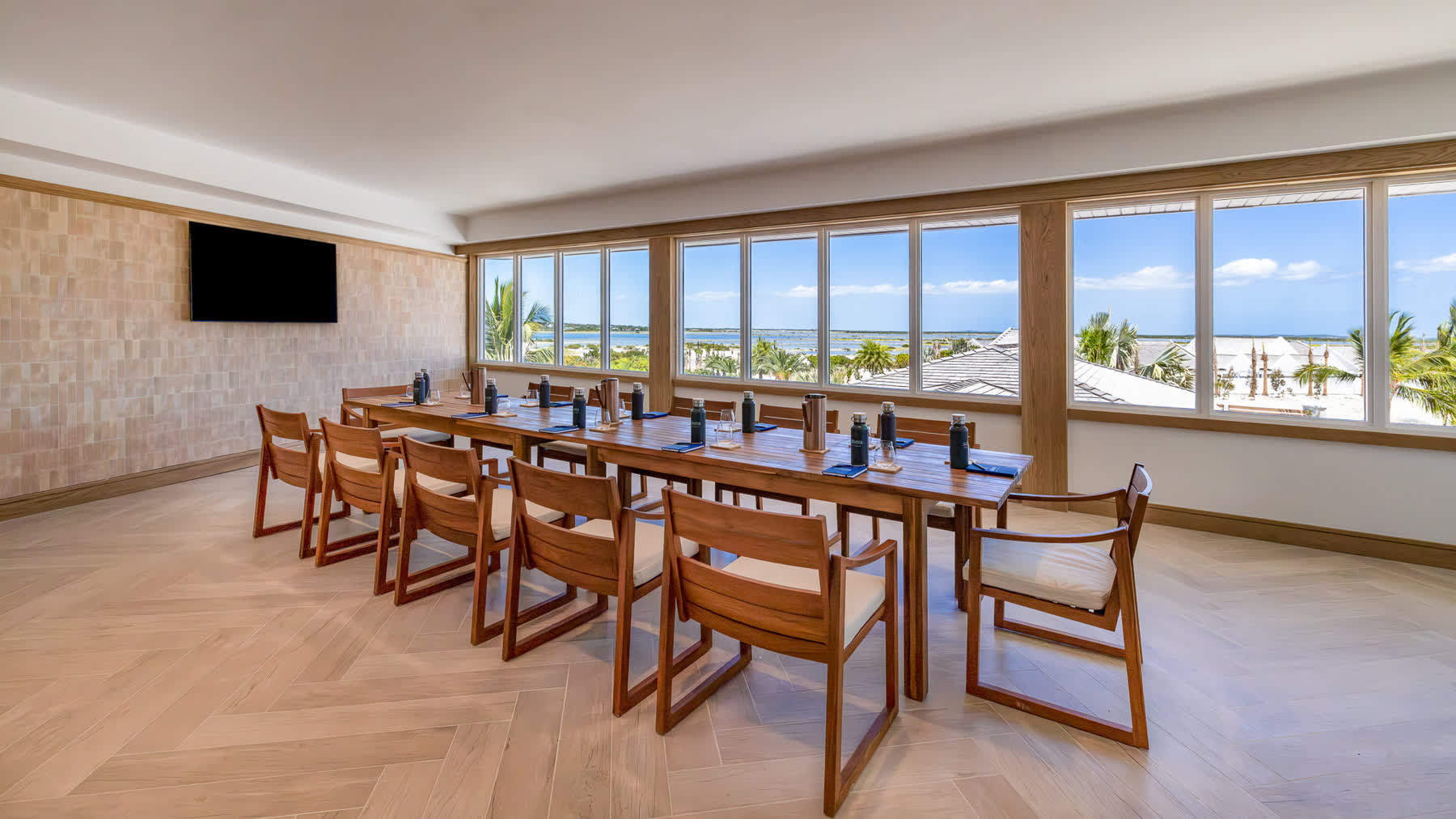 a room with a long table and chairs