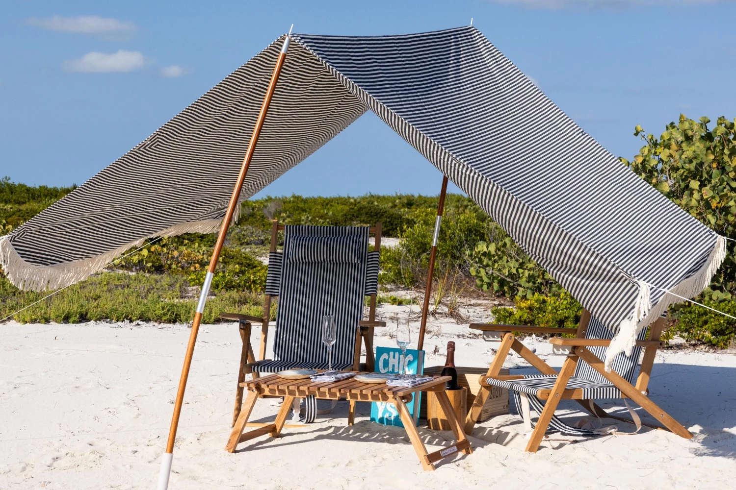 a beach chair and a tent on a beach