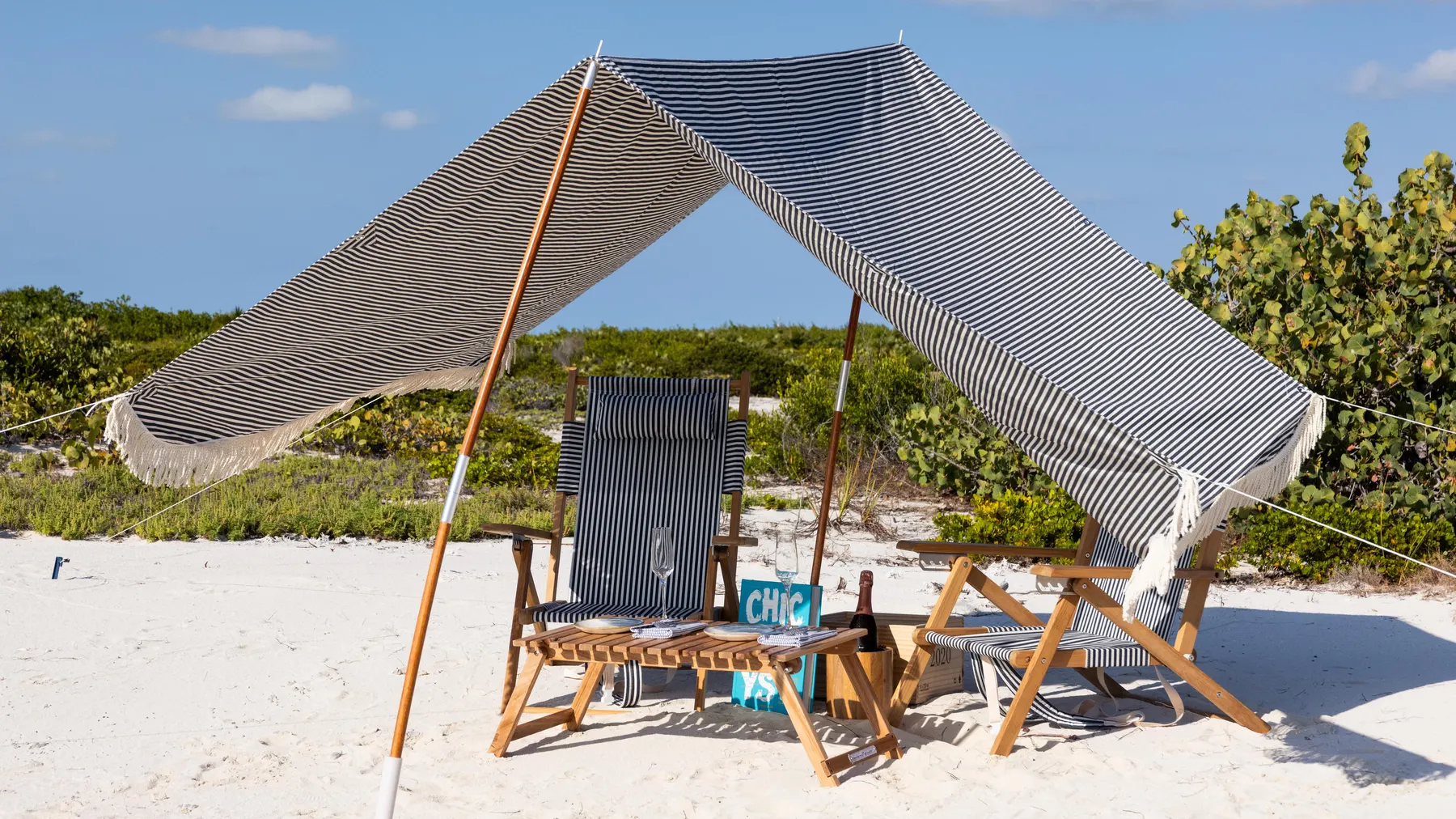 a beach chair and a tent on a beach