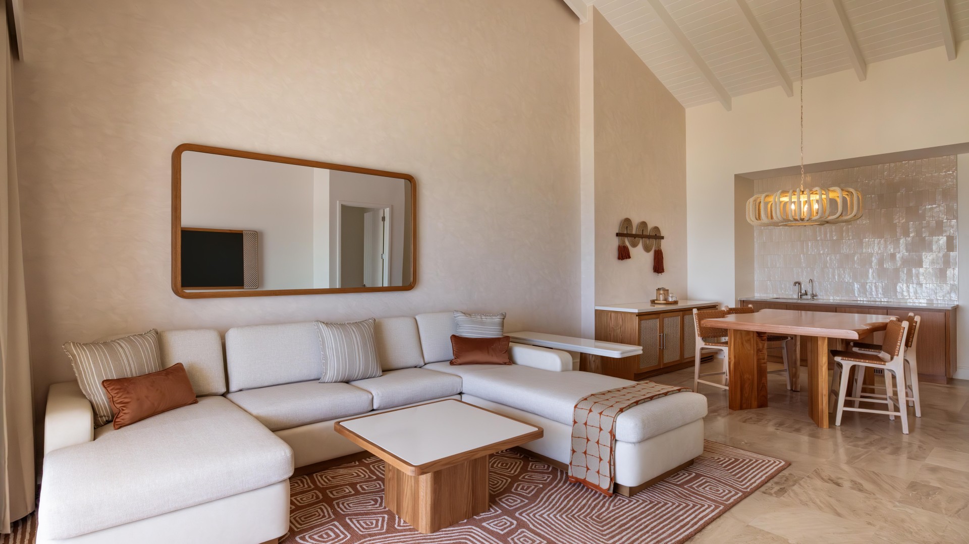 a suite living room with a couch and a table