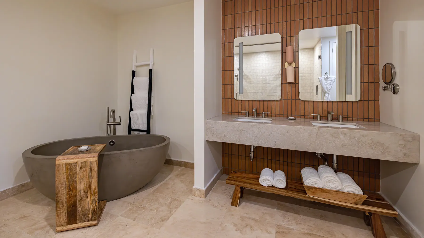 a bathroom with a tub and two mirrors