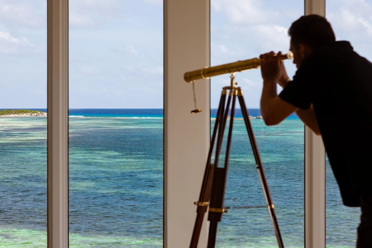 a man looking through a telescope