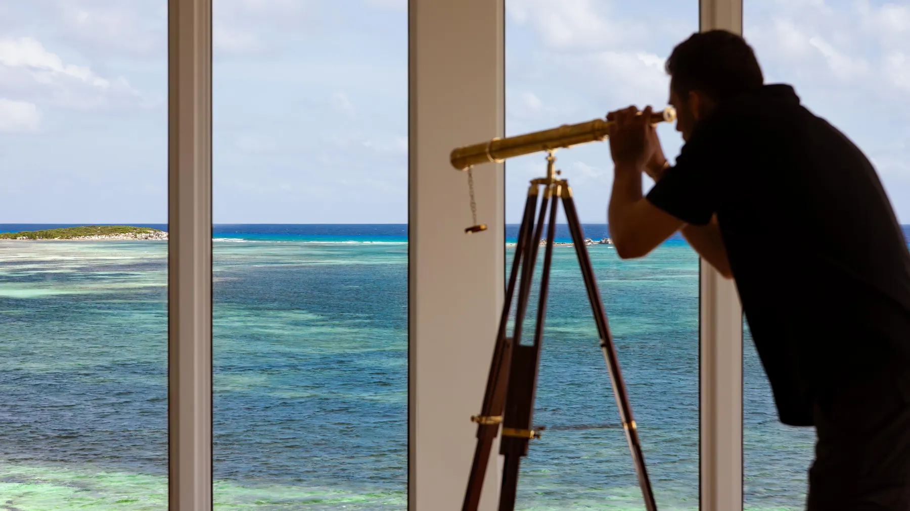 a man looking through a telescope
